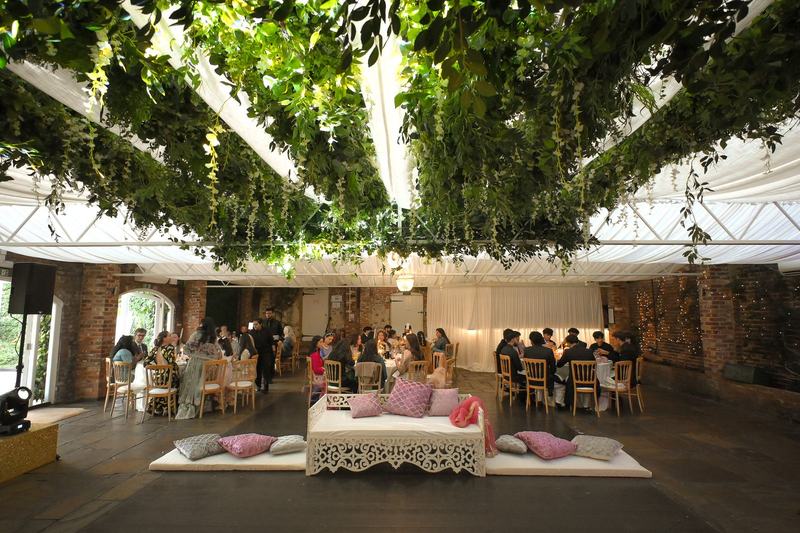 Wedding reception venue draped in greenery