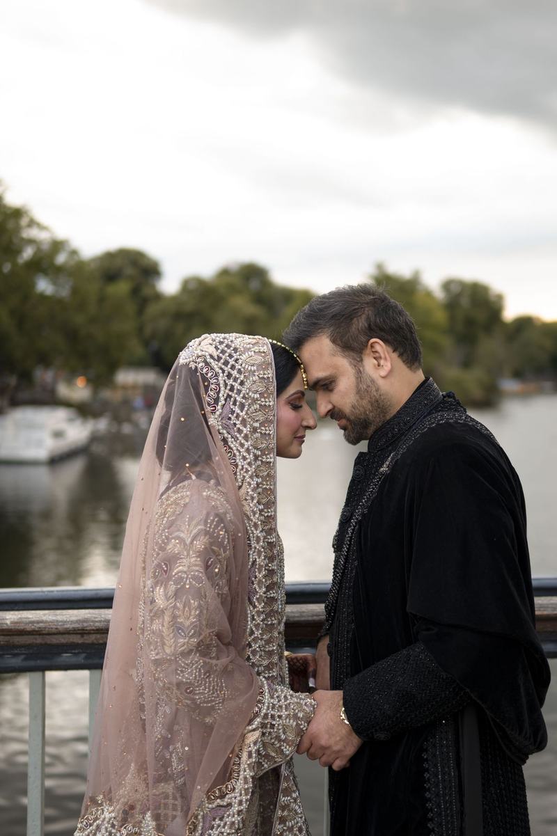 Bride and groom foreheads touching in a romantic portrait