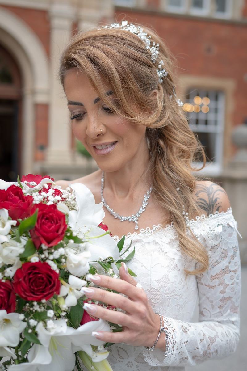 Bride holding red and white bouquet close up