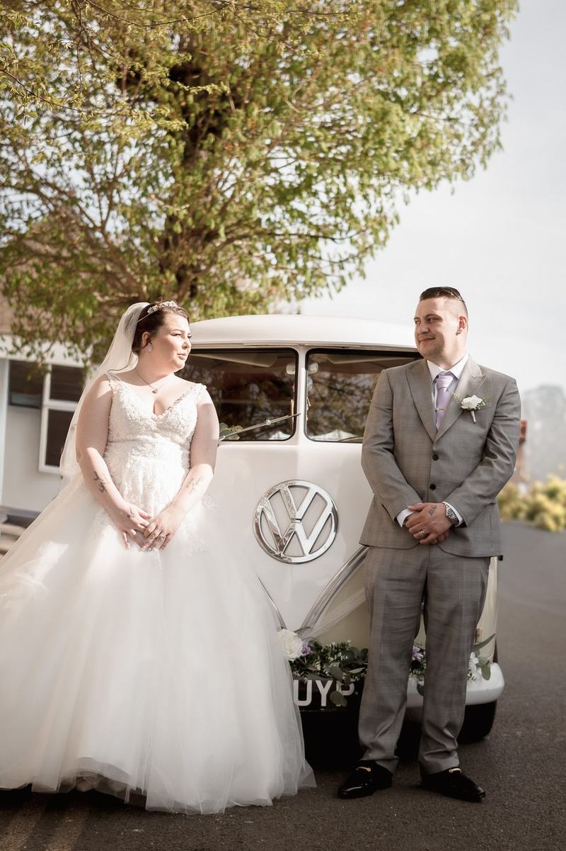 Bride and groom beside a vintage VW wedding car