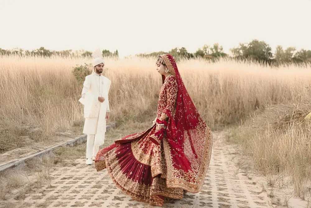 A twirl of the red lehenga at golden hour
