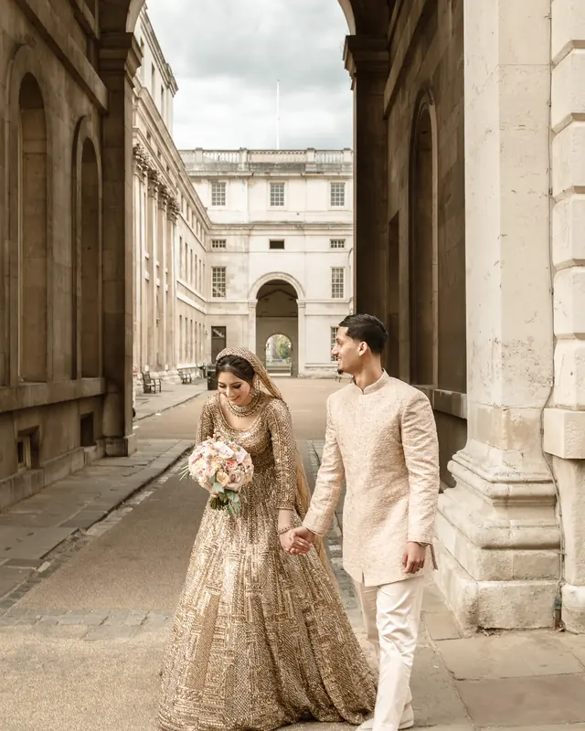 Hand in hand beneath the archway at the Old Royal Naval College, Greenwich