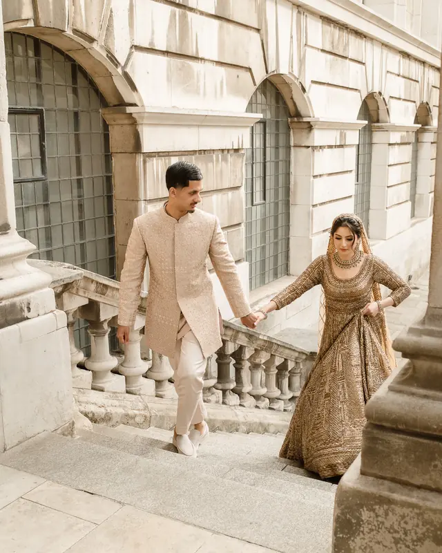 Climbing the stone stairs together, her lehenga in hand