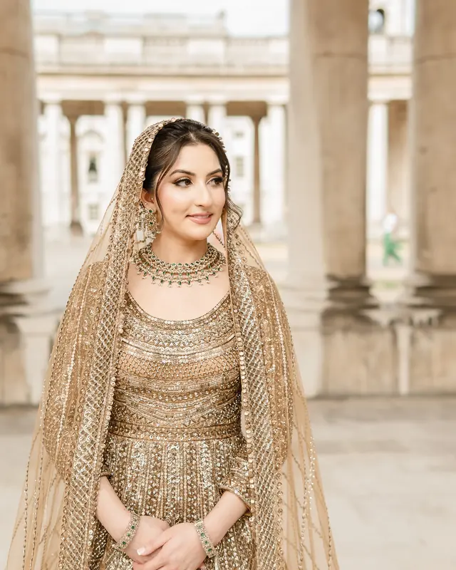 The bride in gold beneath the Greenwich colonnade