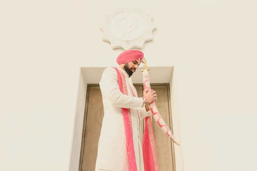 Kamal holding the kirpan before the ceremony