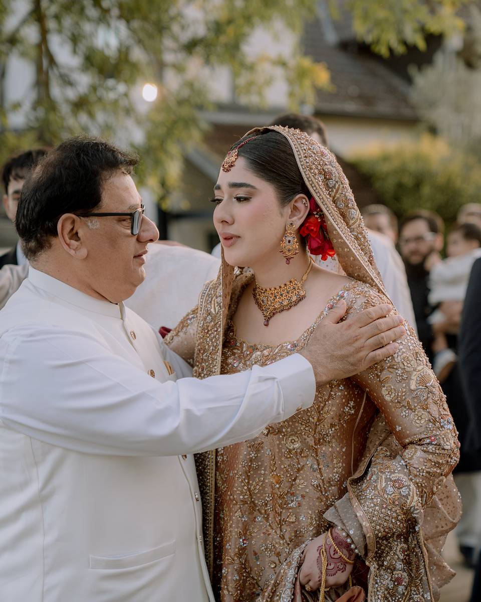 The bride with her father as he blesses her