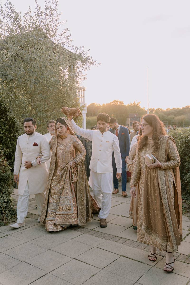 The bride walks out beneath the Quran at sunset