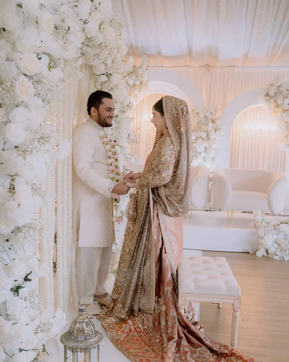 The couple on the white floral stage