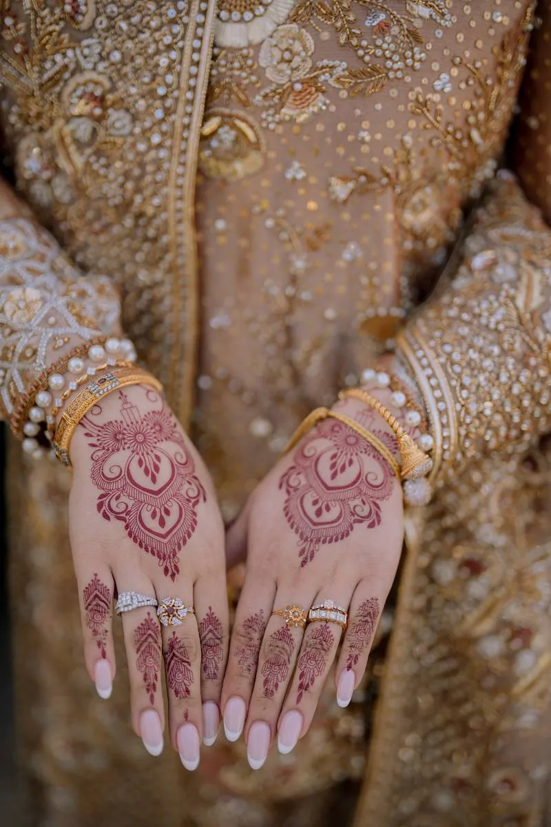Mehndi hands and bridal rings