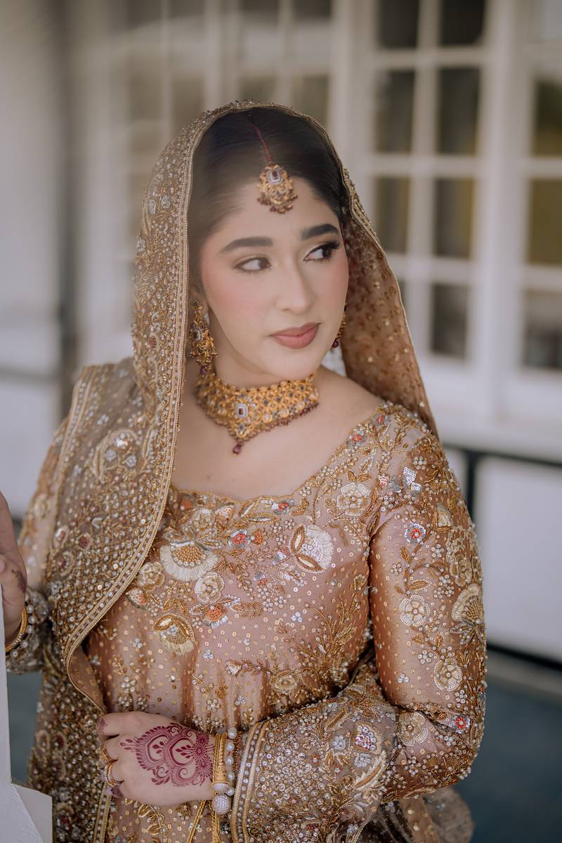 The bride in gold by the pavilion windows