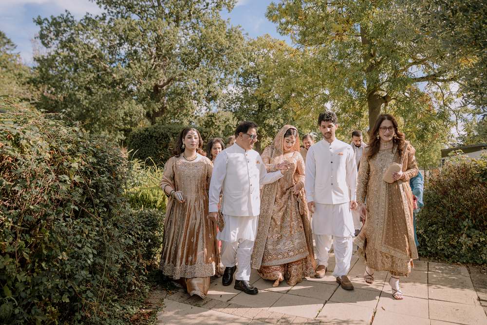 The groom walks in with his family