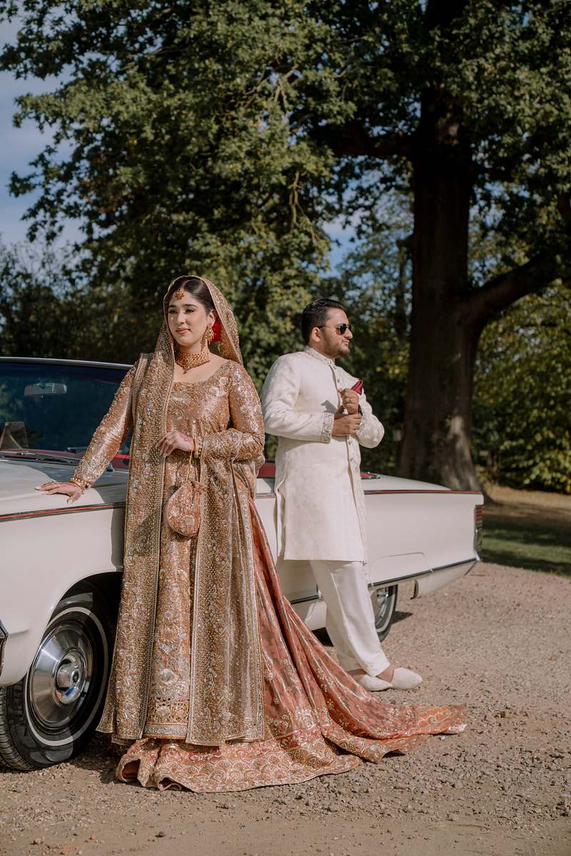 The couple beside the vintage convertible