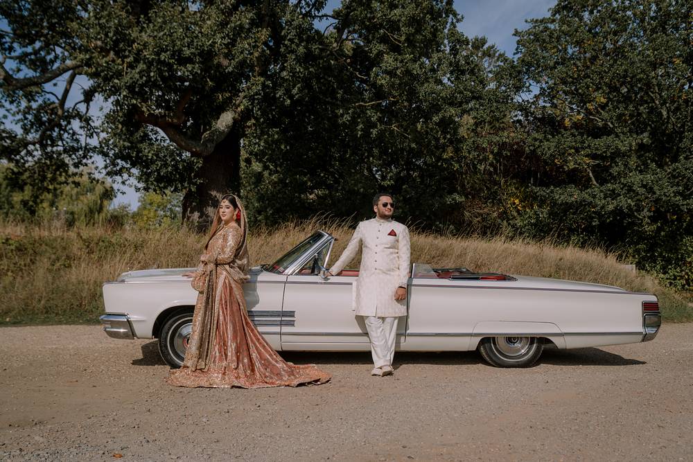 A wide portrait with the vintage car beneath the oak