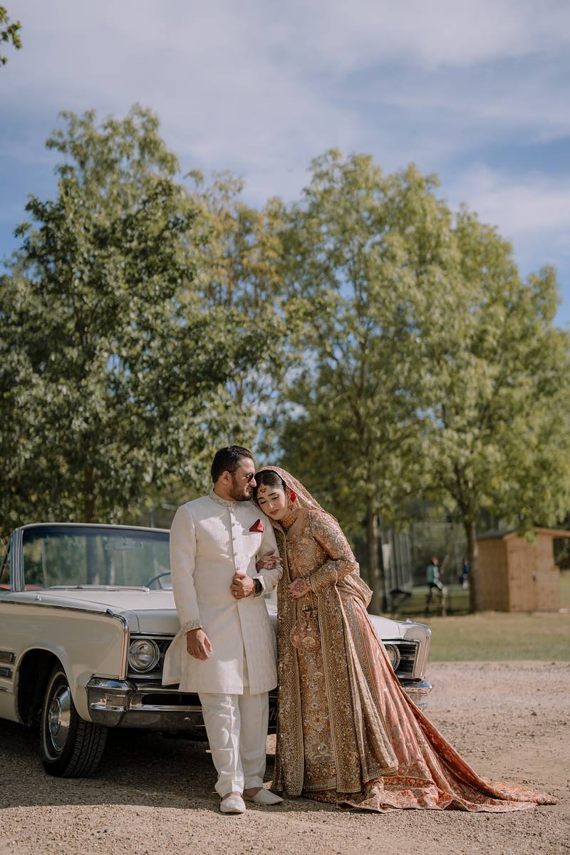 A shared smile against the vintage car