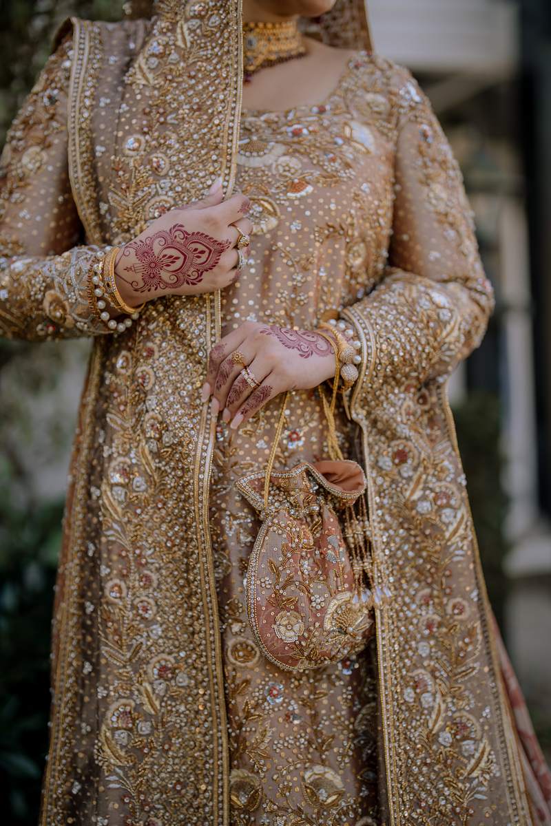 Mehndi hands and the bridal potli