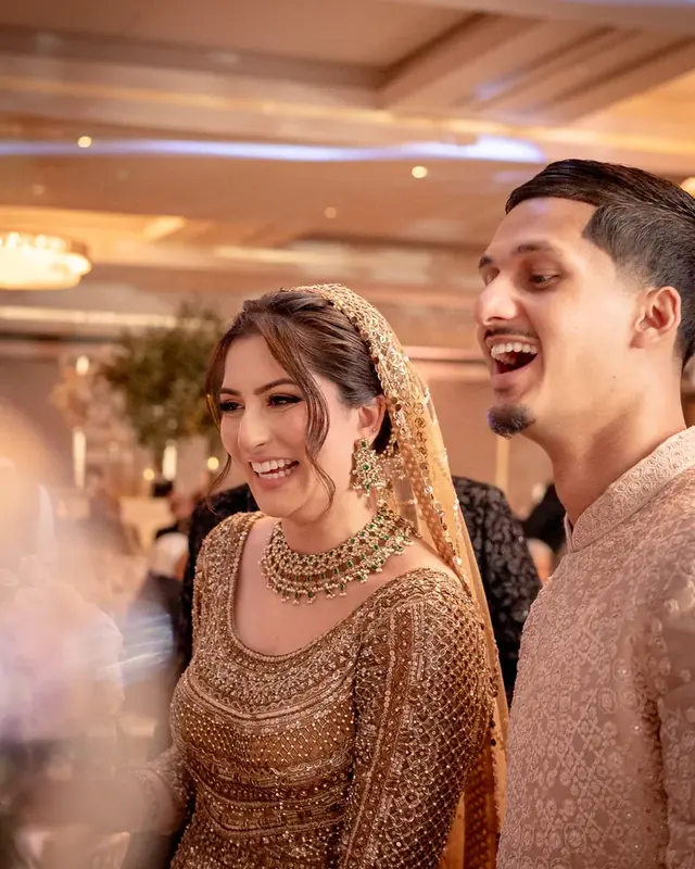 The couple laughing together inside the Peninsula Ballroom