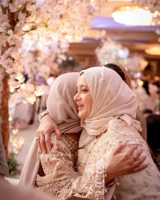 A warm embrace beneath the cherry blossom