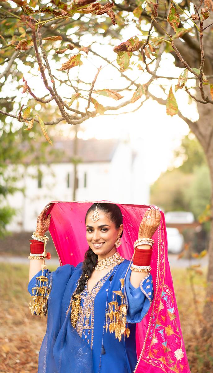 The phulkari dupatta raised beneath the autumn tree