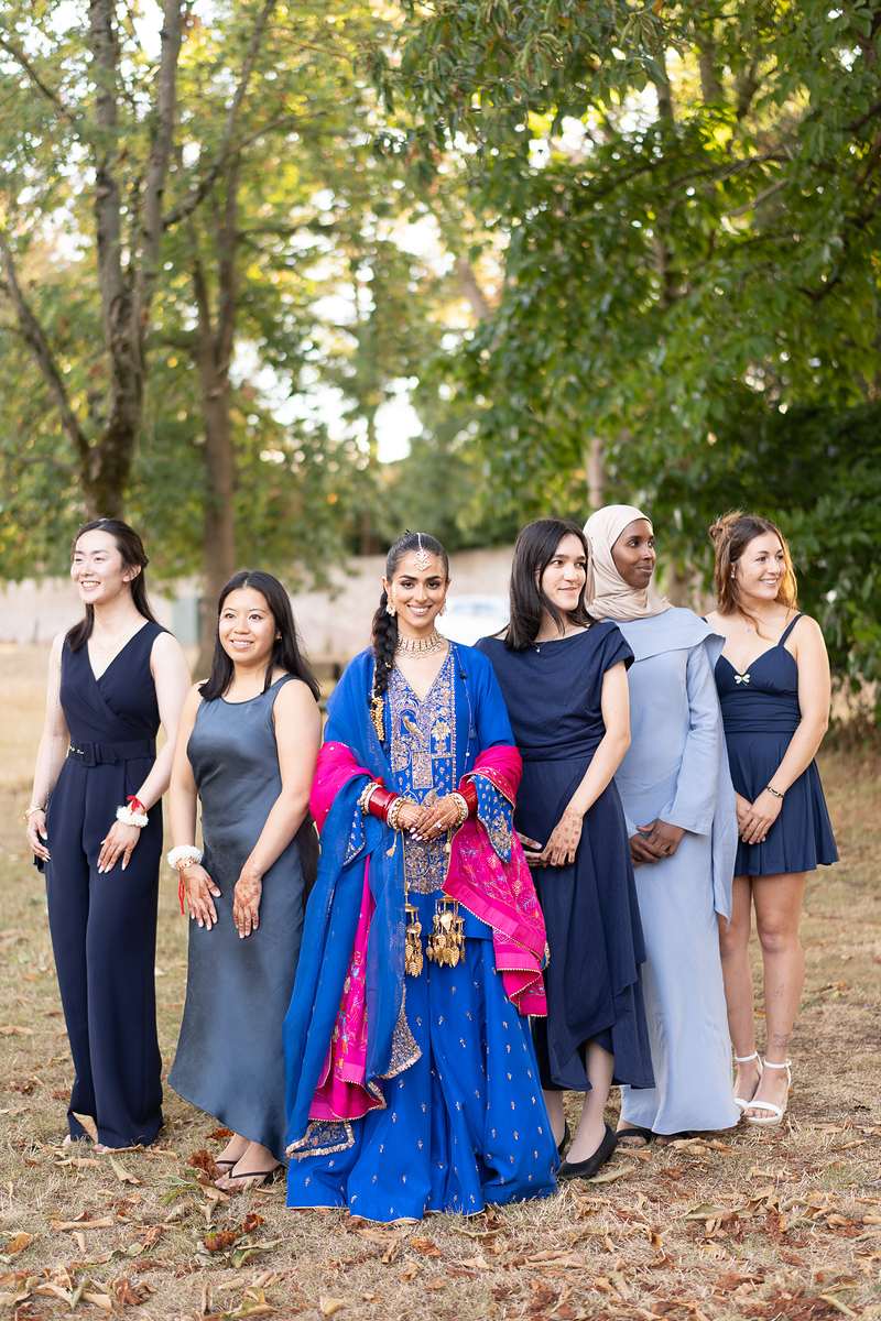 The bride with her friends among the autumn leaves
