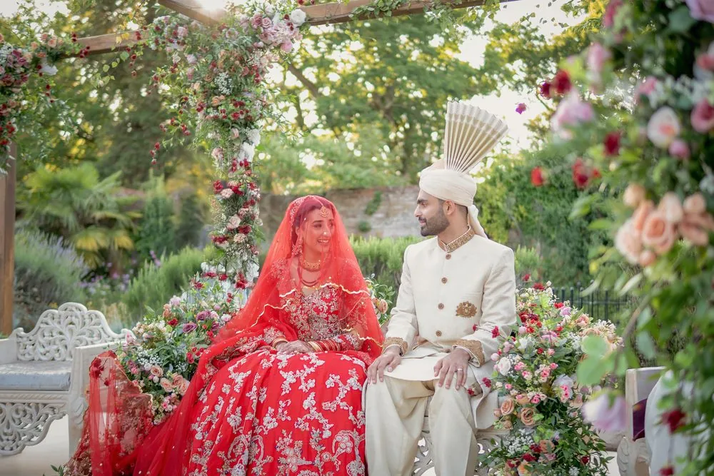 Sharing a smile beneath the floral arch