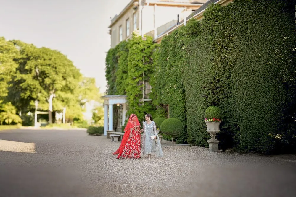 The bride walking with her sister at the house