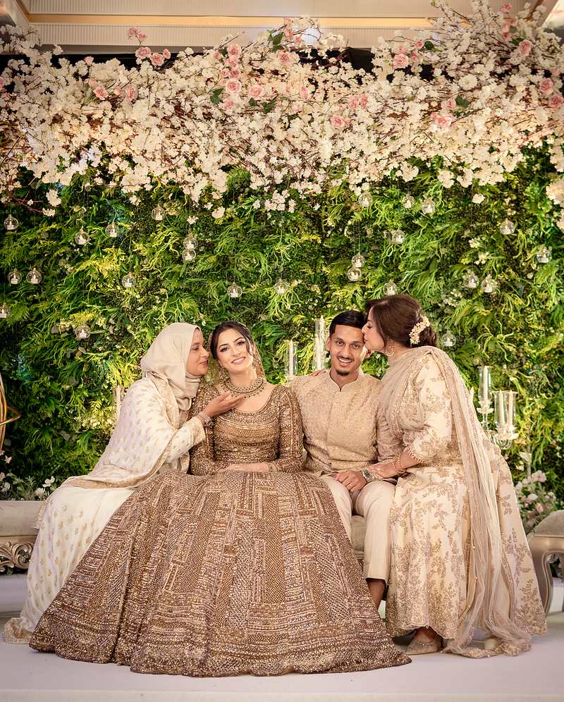 Family blessings for the couple on the floral stage