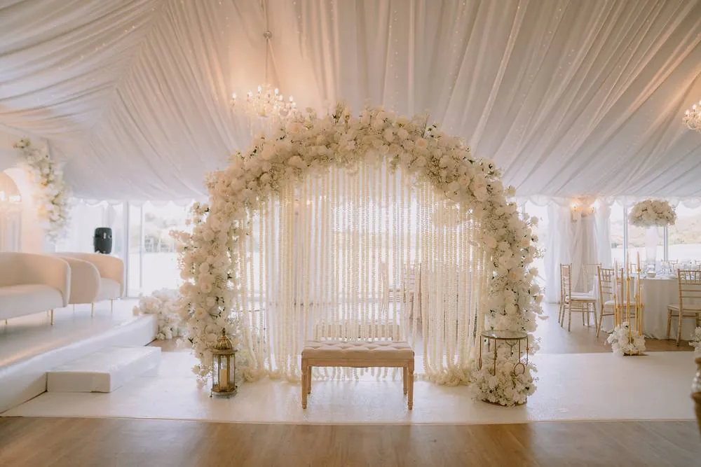 A white floral arch set for the ceremony