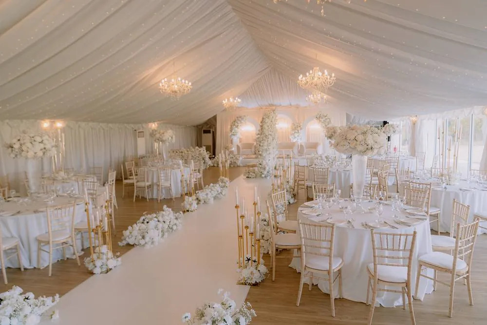 The marquee dressed in white florals and chandeliers