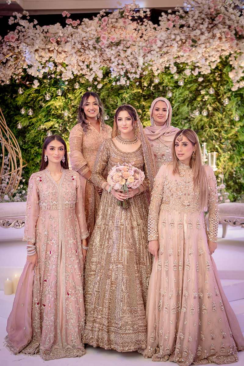 The bride with her bridesmaids on the floral stage
