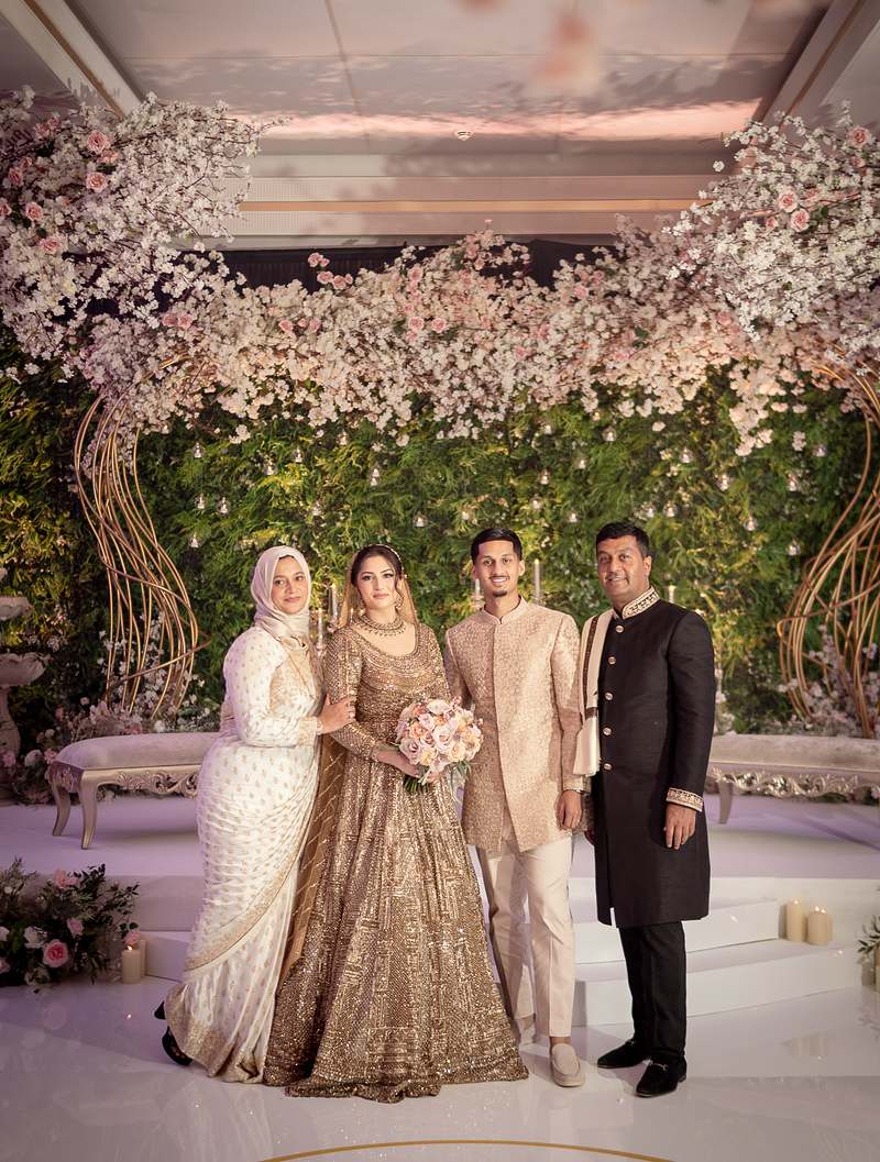 The couple with family on the reception stage