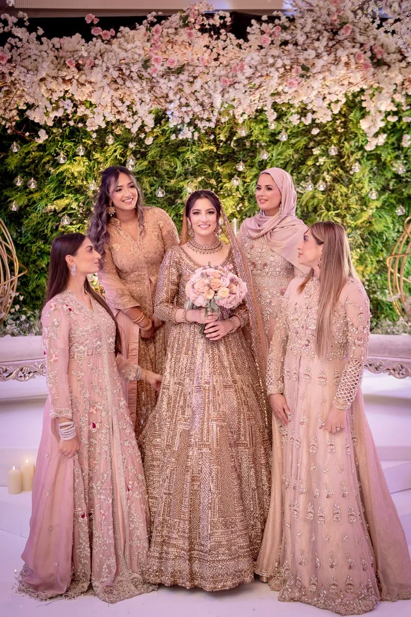Bride holding her bouquet with her bridesmaids at the Peninsula Ballroom