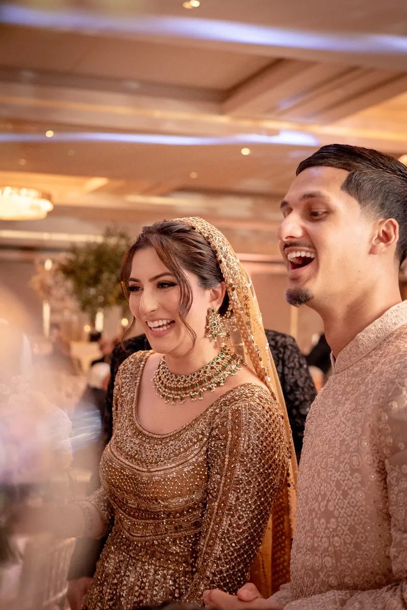 Bride and groom laughing together at their Peninsula Ballroom reception